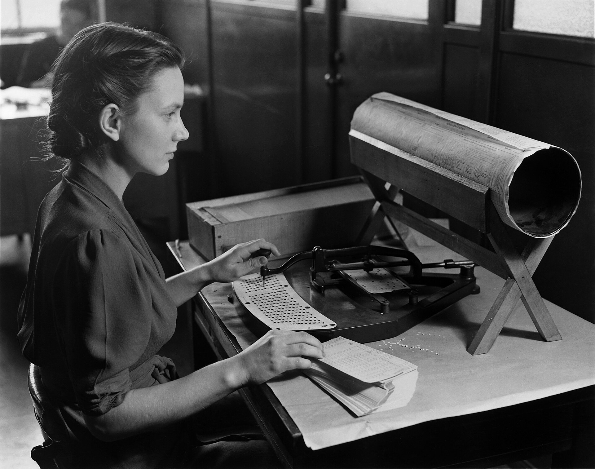 An operator punching census cards by hand, around 1940